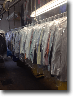 line of hanging dry cleaning on a rack